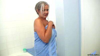 Granny is teasing on webcam and fingering her self in a bathroom - sunporno.com