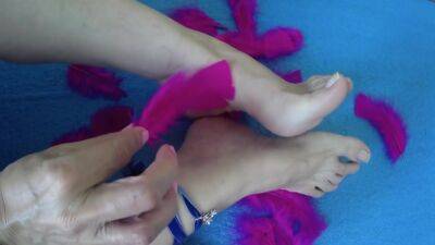 Mature Woman Puts Her Feet On Fire Rubbing Them With Soft Feathers - hclips.com